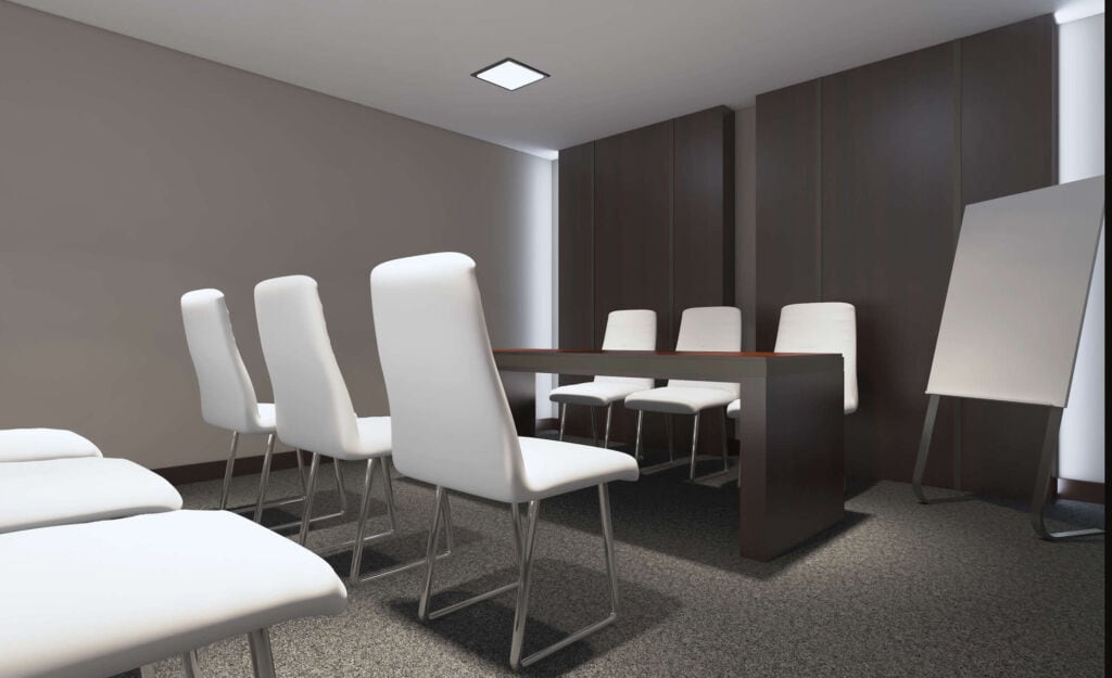 white chairs around a table in a dark room